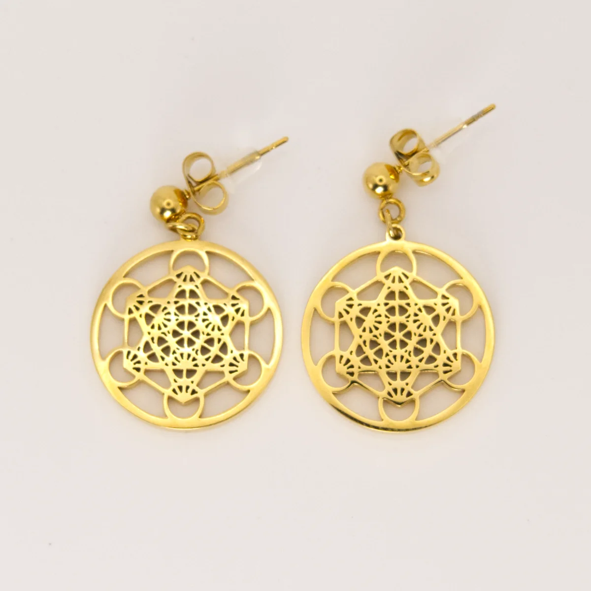 Sacred Geometry earrings laid flat